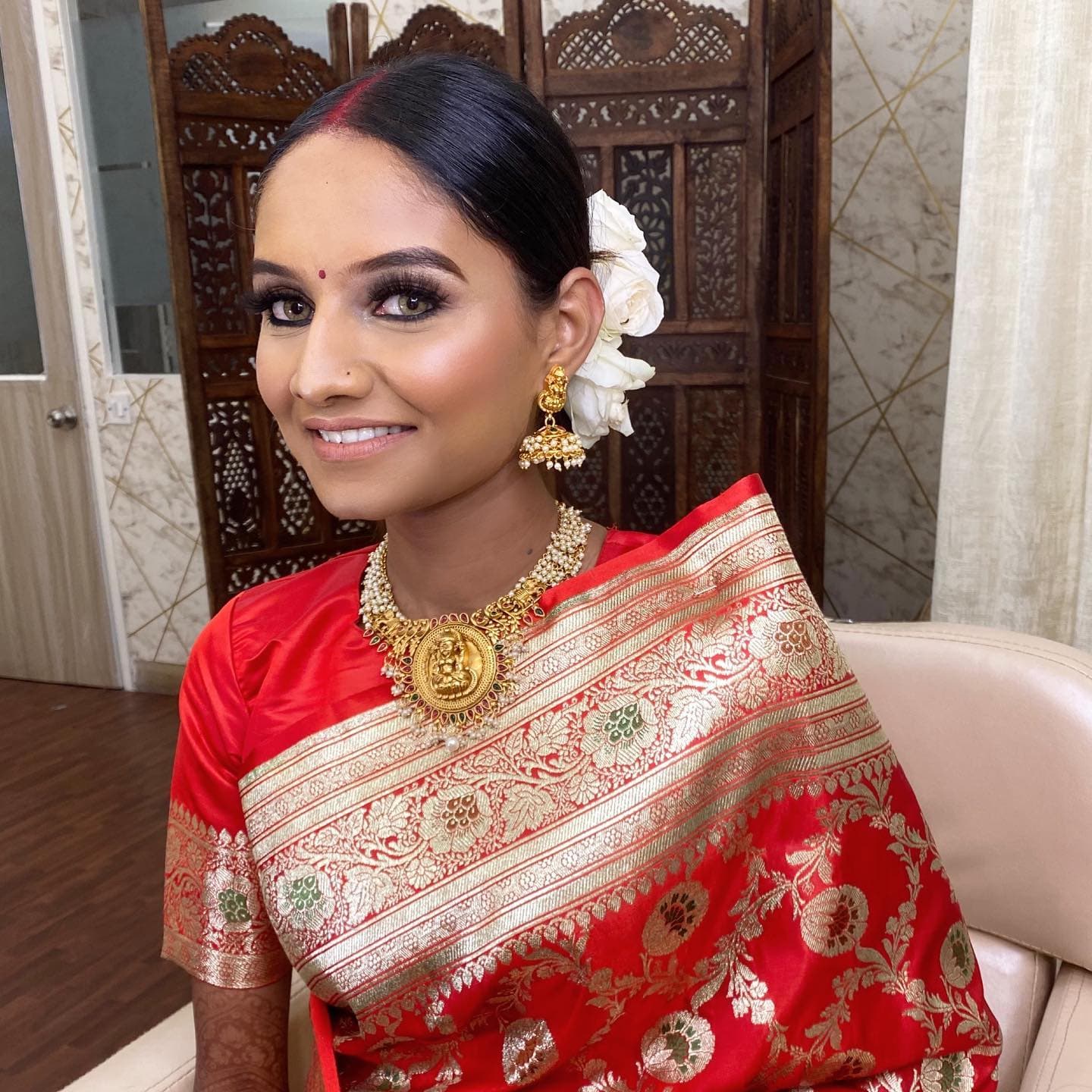 Bride in a silk saree with bridal makeup by MG Makeovers