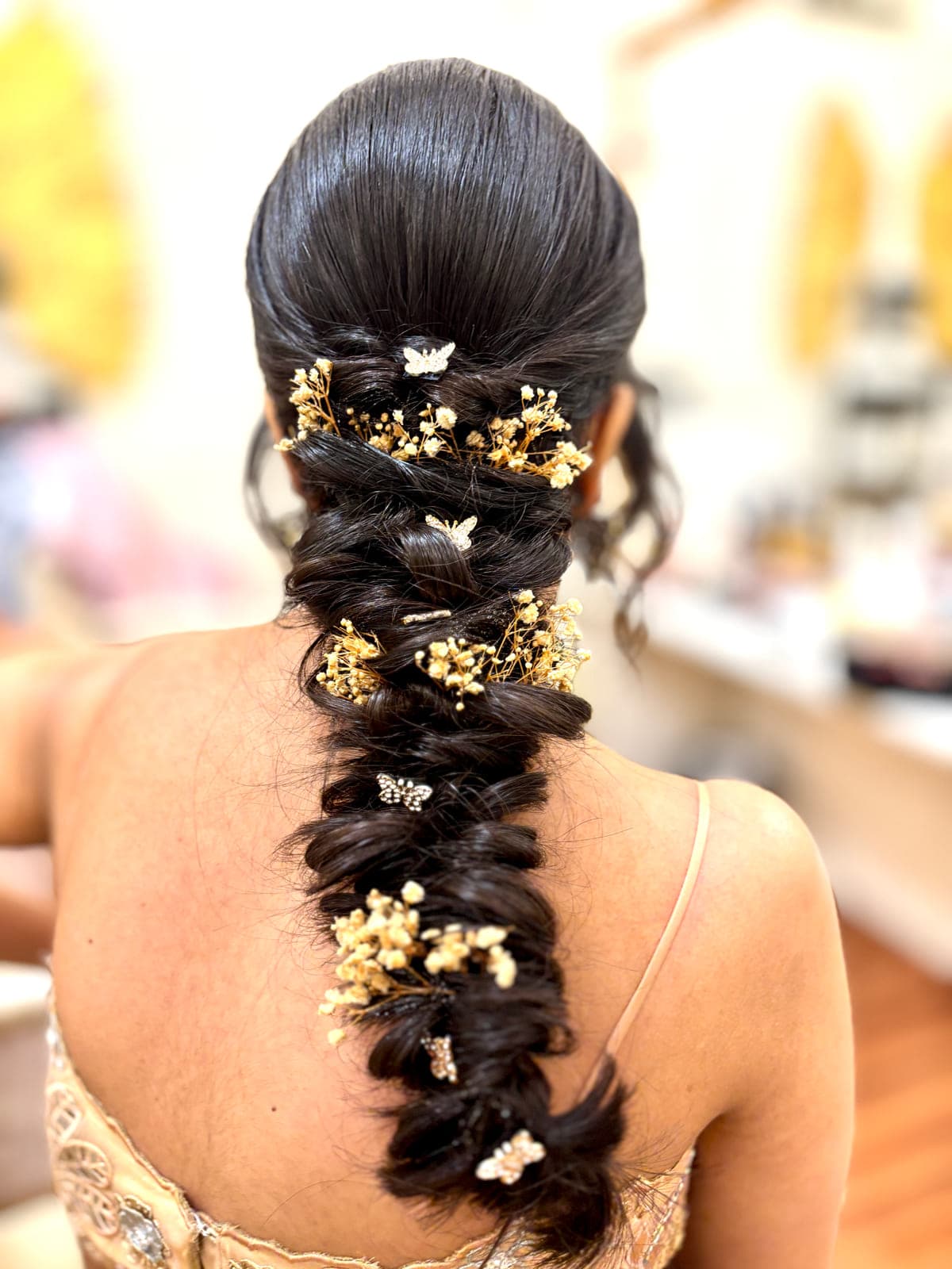 Gold-accented braided hairstyle by MG Makeovers