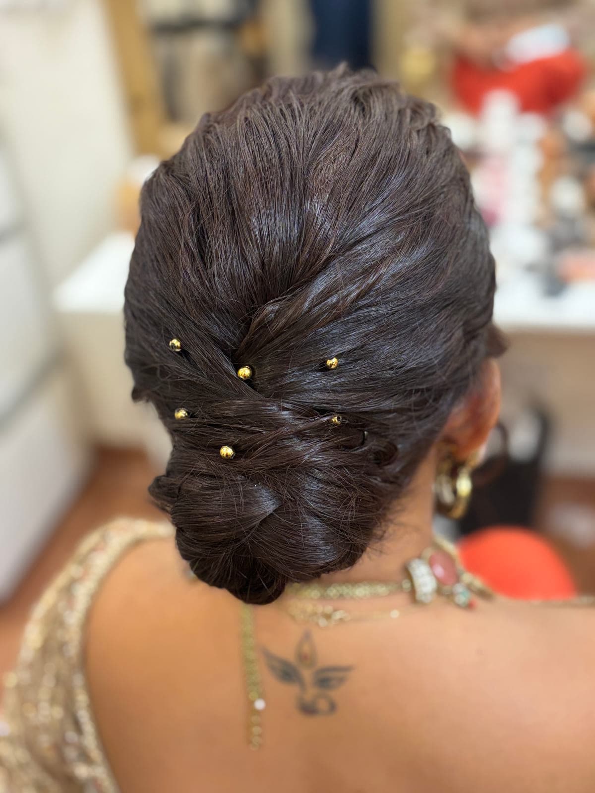 Messy bun hairstyle with beads by MG Makeovers