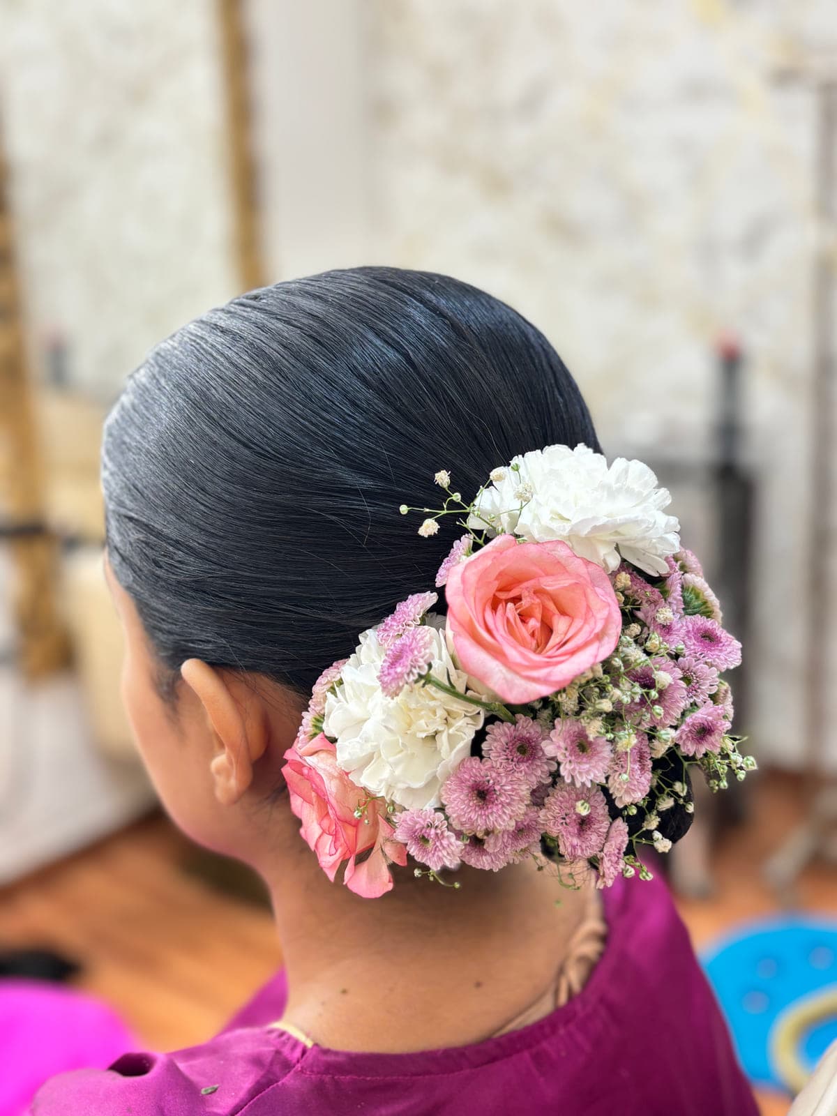 Sleek bun hairstyle with roses by MG Makeovers