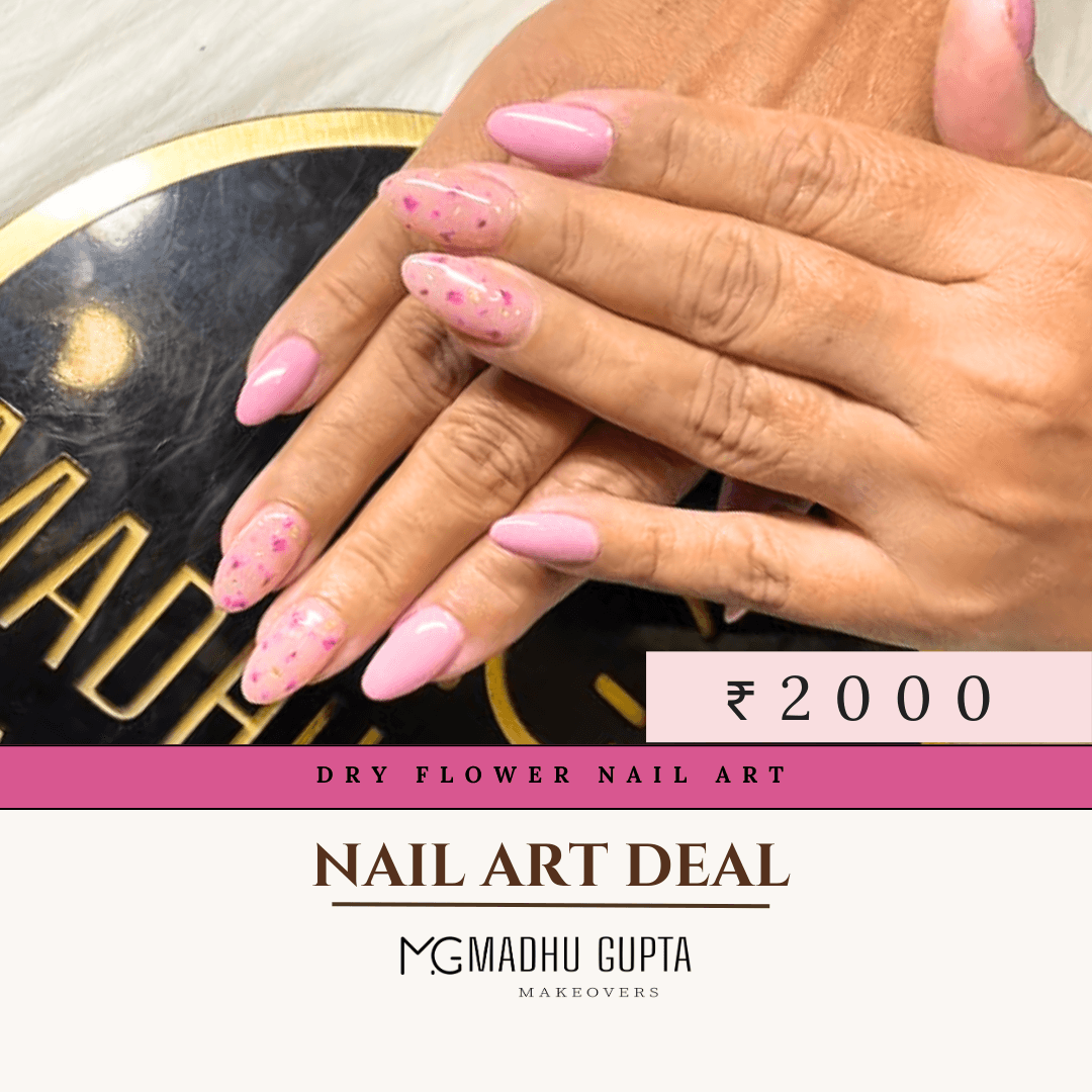 Pink nails set with dry flower petals and glitter at MG Makeovers, Gurgaon