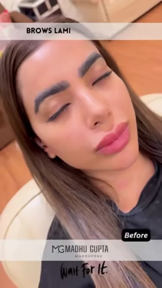Video thumbnail: client with eyes closed and brows brushed up before brow lamination, captioned 'Brows lami, before, wait for it'