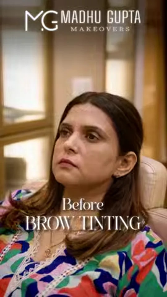 Video thumbnail: client in a colourful printed top seated in the MG Makeovers studio, captioned 'Before brow tinting'