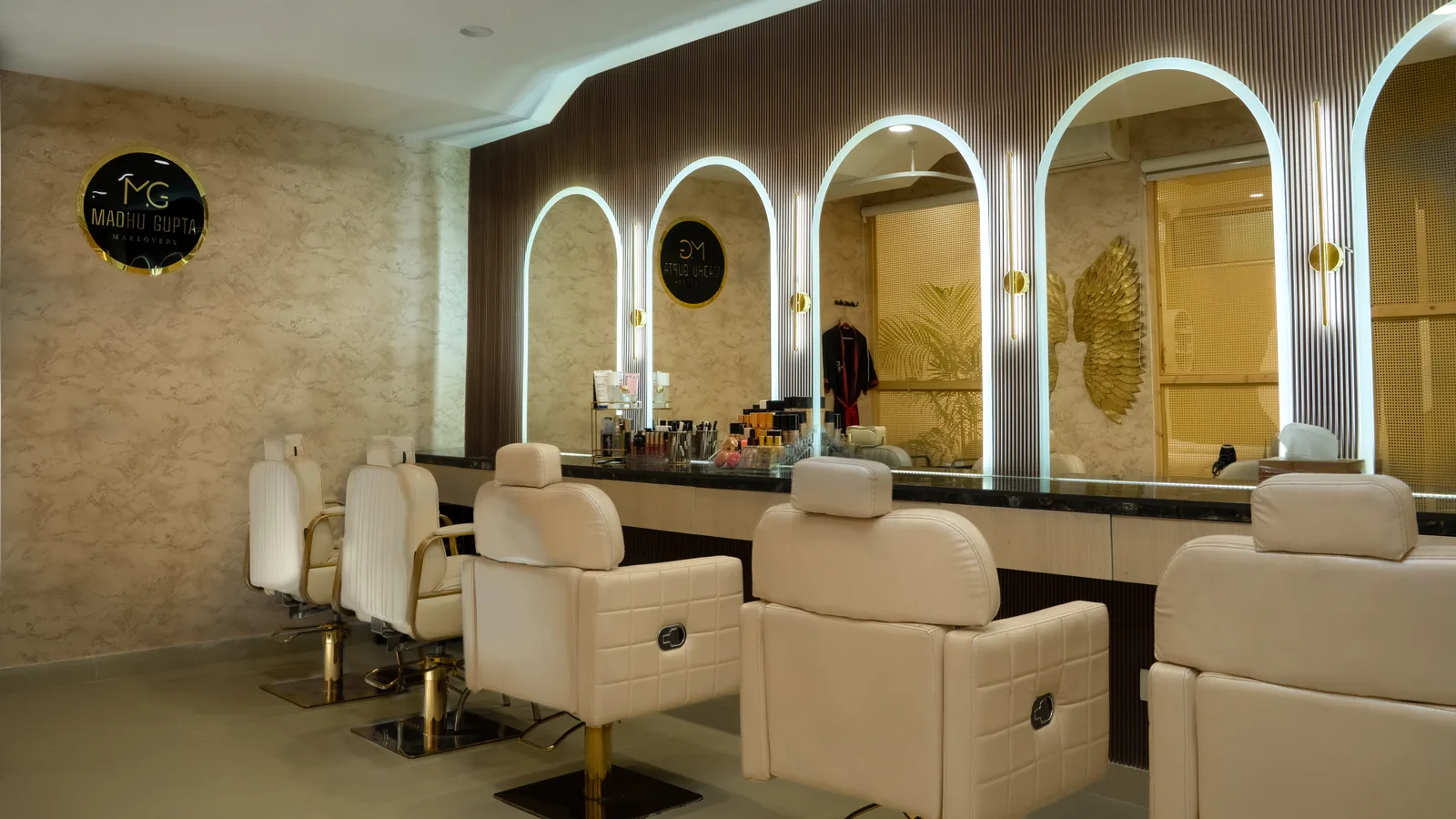 Bridal makeup room with illuminated mirrors and styling chairs at MG Makeovers