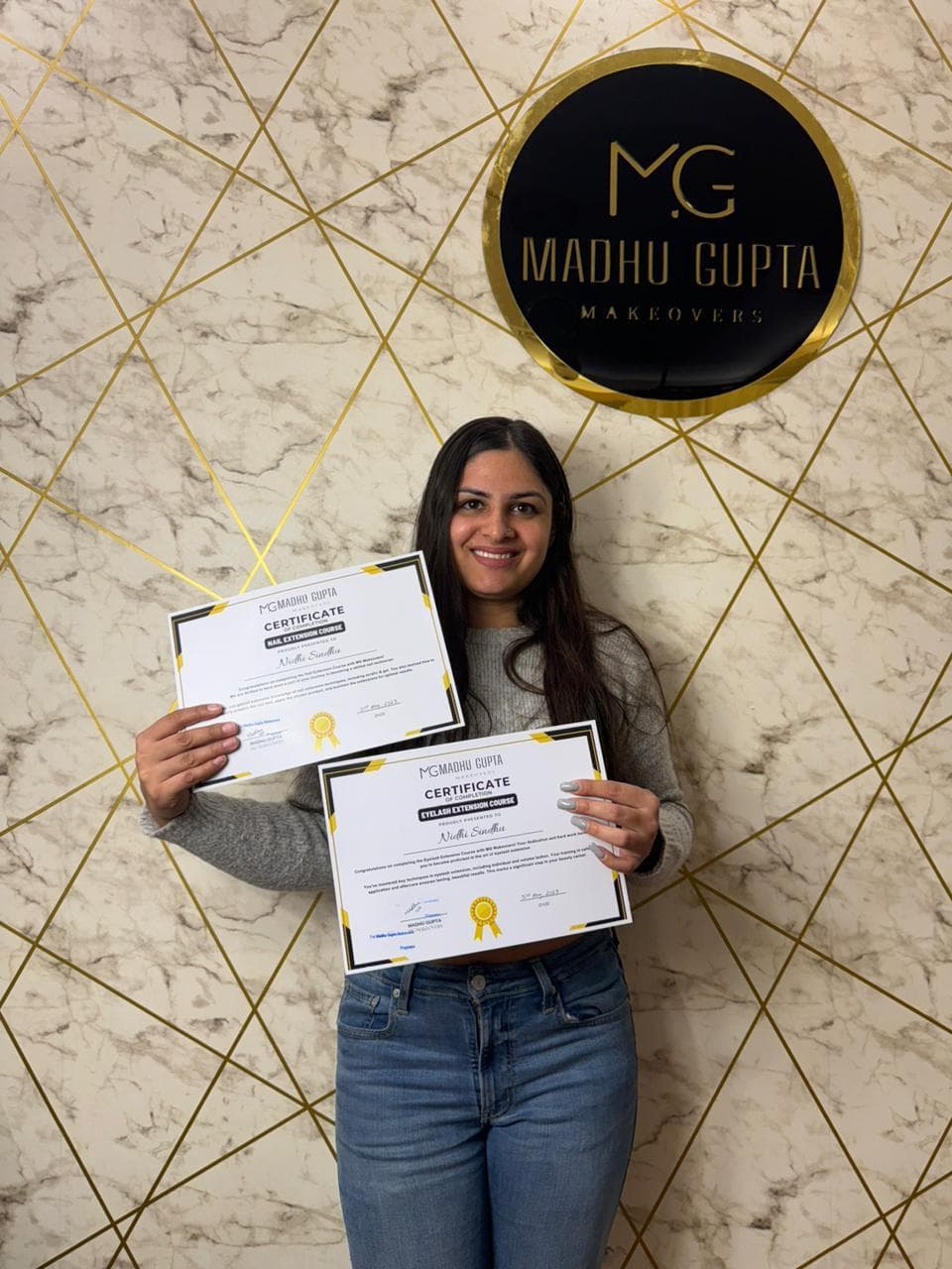Eyelash extension course student with their MG Makeovers certificate