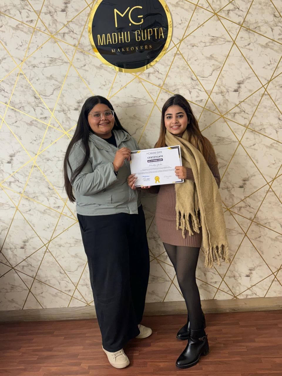 Eyelash extension course student with their MG Makeovers certificate