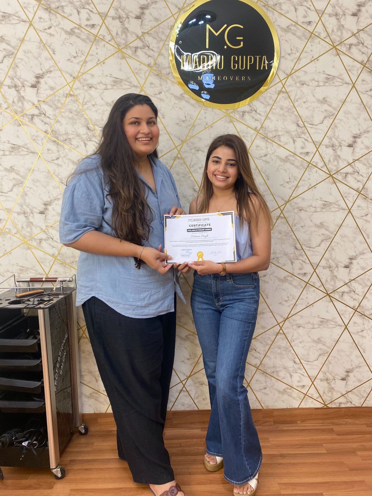 Eyelash extension course student with their MG Makeovers certificate