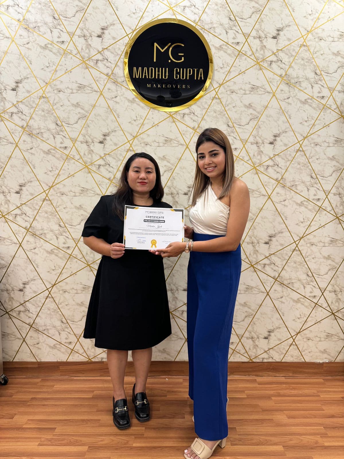 Eyelash extension course student with their MG Makeovers certificate