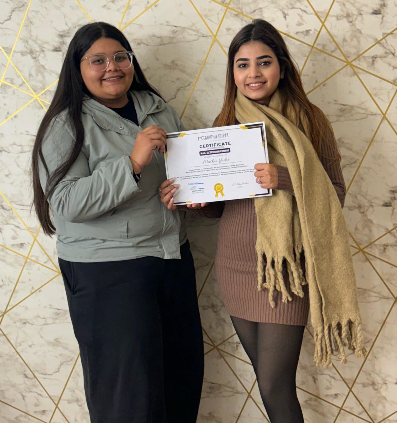 A student receiving her MG Makeovers Academy certificate