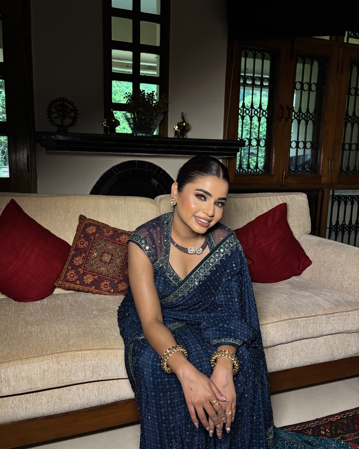 Madhu Gupta, founder and lead artist at MG Makeovers, in a navy embellished saree