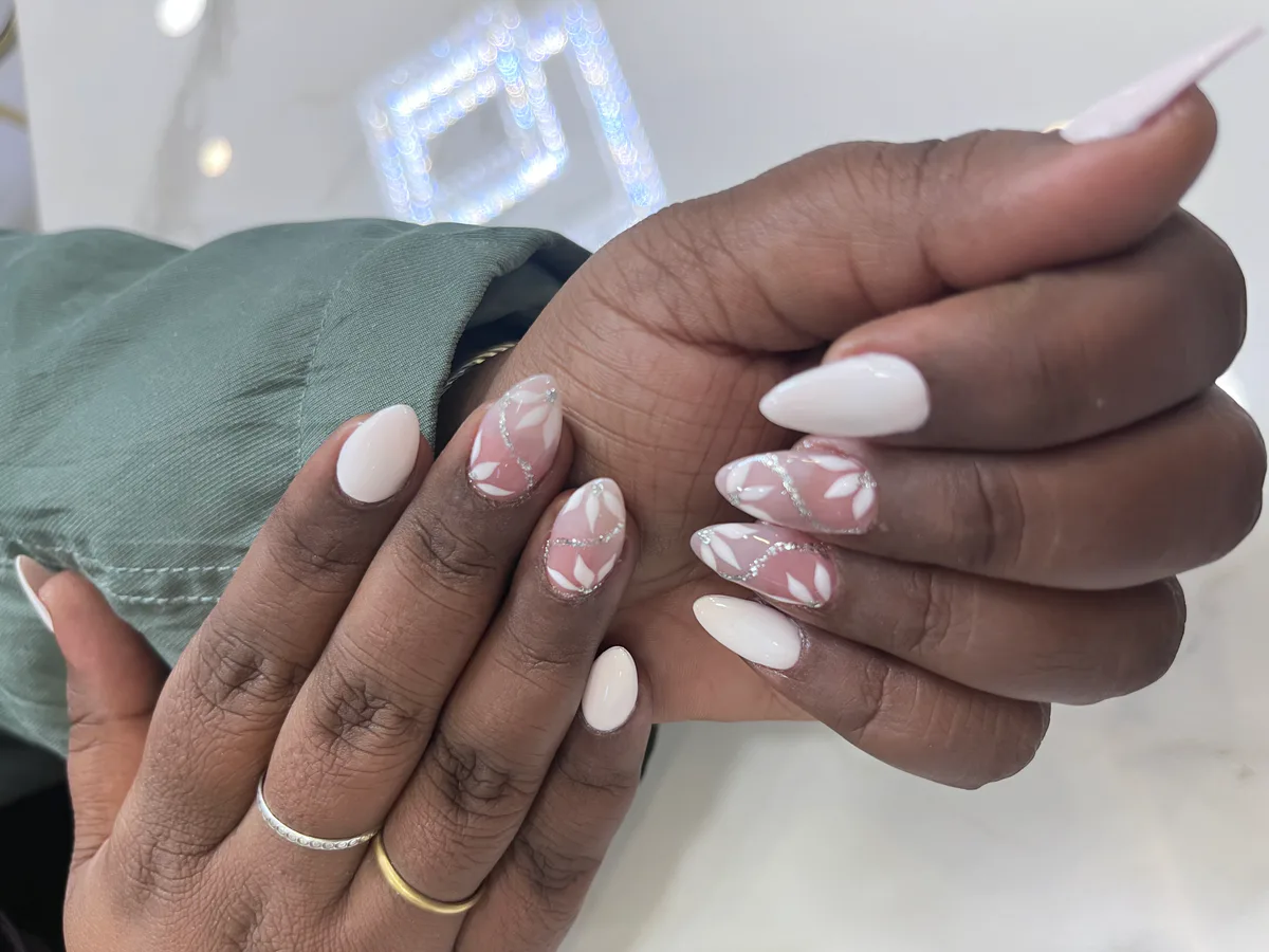 White and pink nail extensions with three-dimensional floral detail by MG Makeovers