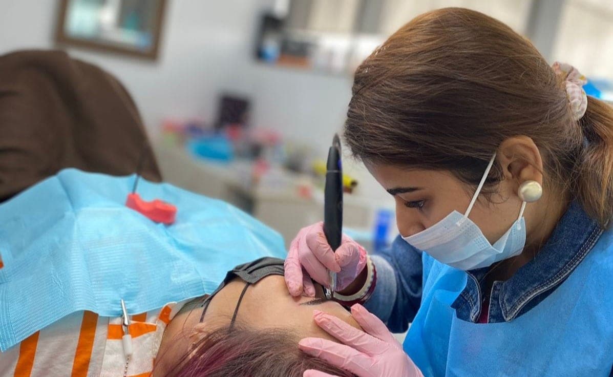 Madhu Gupta performing a permanent makeup brow procedure in Gurgaon