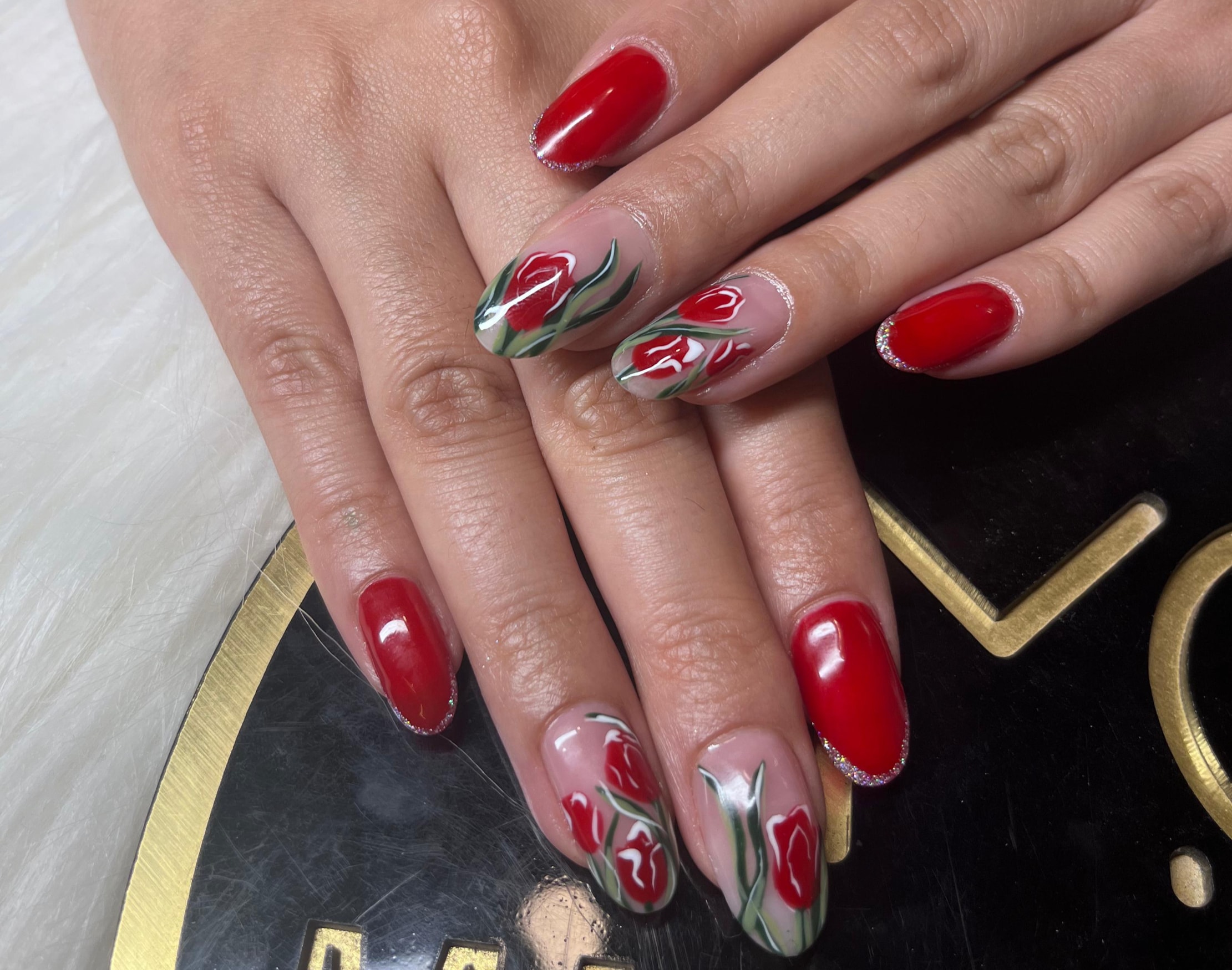 Red stiletto nails with unique designs showcased in Gurgaon, making a fashion statement