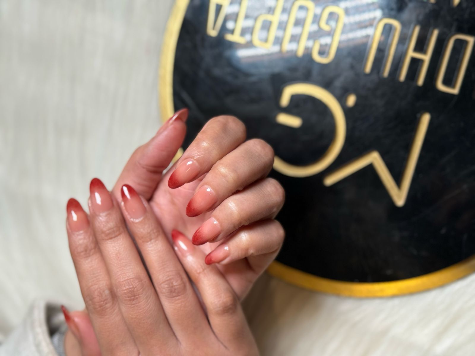 Hands displaying luxury gold nail design at MG Makeovers, Gurgaon