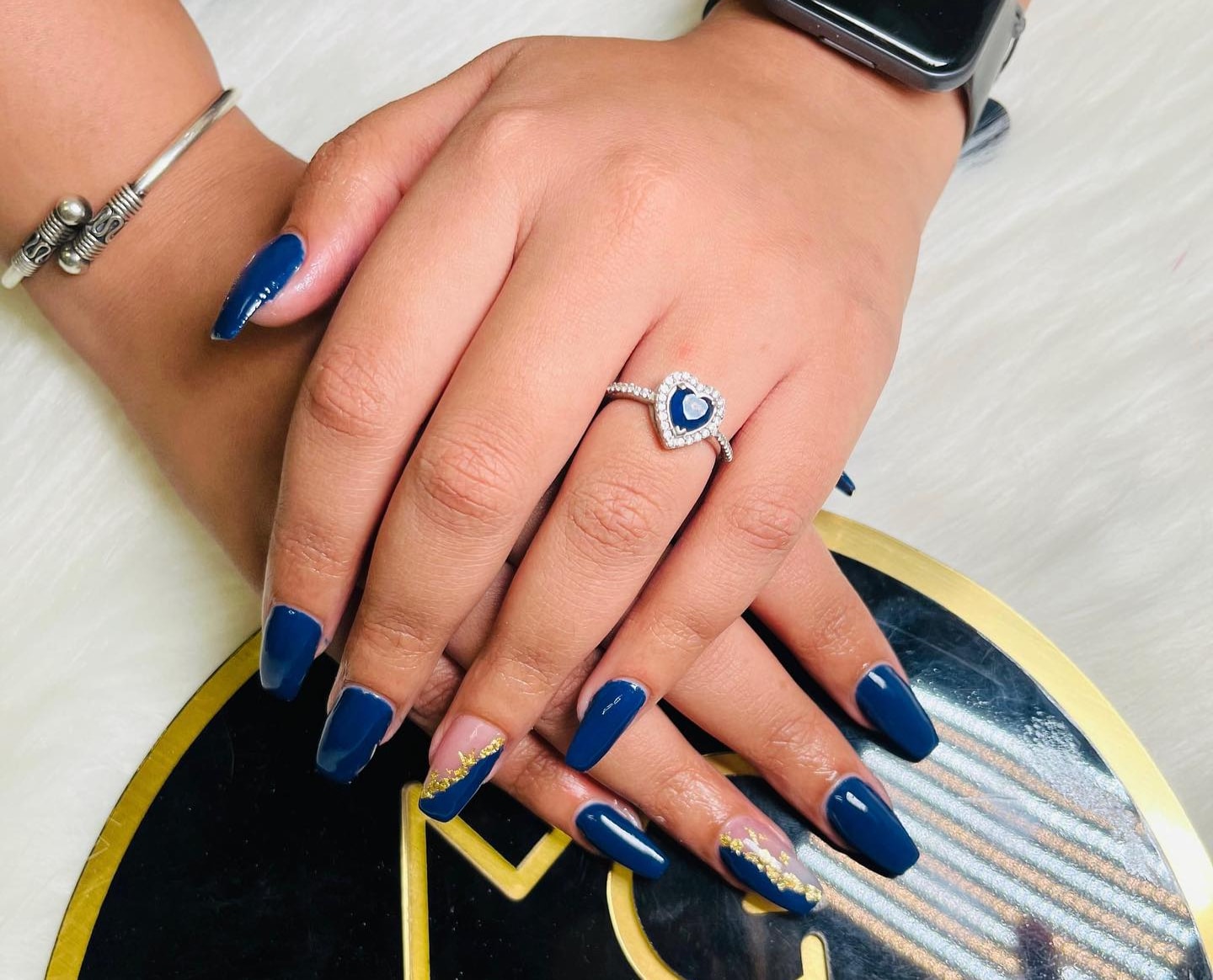 Sophisticated blue nails with gold detailing, trending at MG Makeovers in Gurgaon.